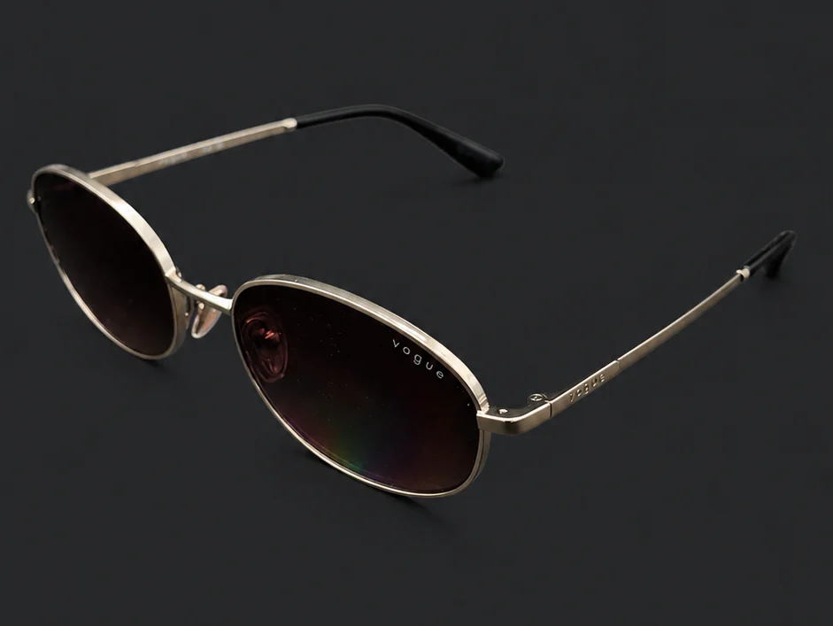 Ramă Vogue ovală aurie văzută din profil, cu brațe subțiri metalice, disponibilă la ArenaMed Optics