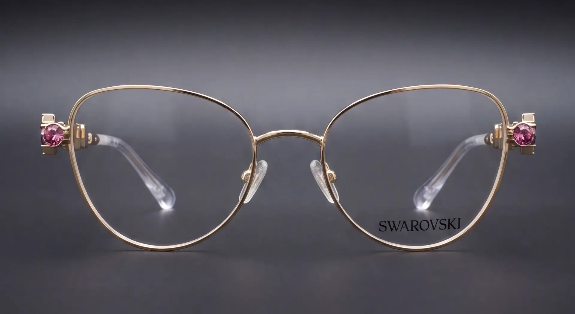 Ramă Swarovski aurie cat-eye, vedere frontală cu cristale roz pe balamale, disponibilă la ArenaMed Optics