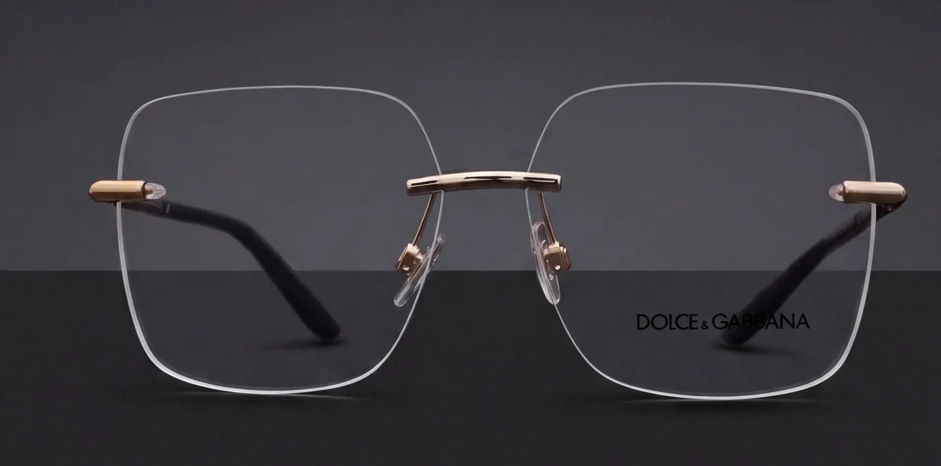 Ramă Dolce & Gabbana rimless cu punte aurie, vedere frontală, disponibilă la ArenaMed Optics